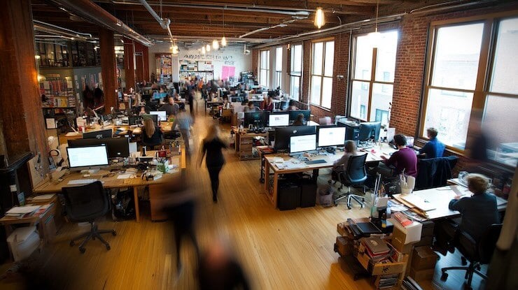 A_bustling_office_environment_startup_vibes_blurred_ef167a31-6cac-48b5-b5d0-cd2da81800f6_0